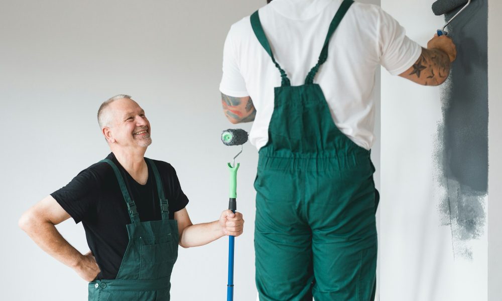 Professional renovation crew painting walls of new build apartment